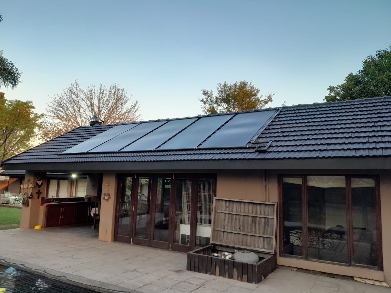 Solar pool heating panel installation on a residential tile roof